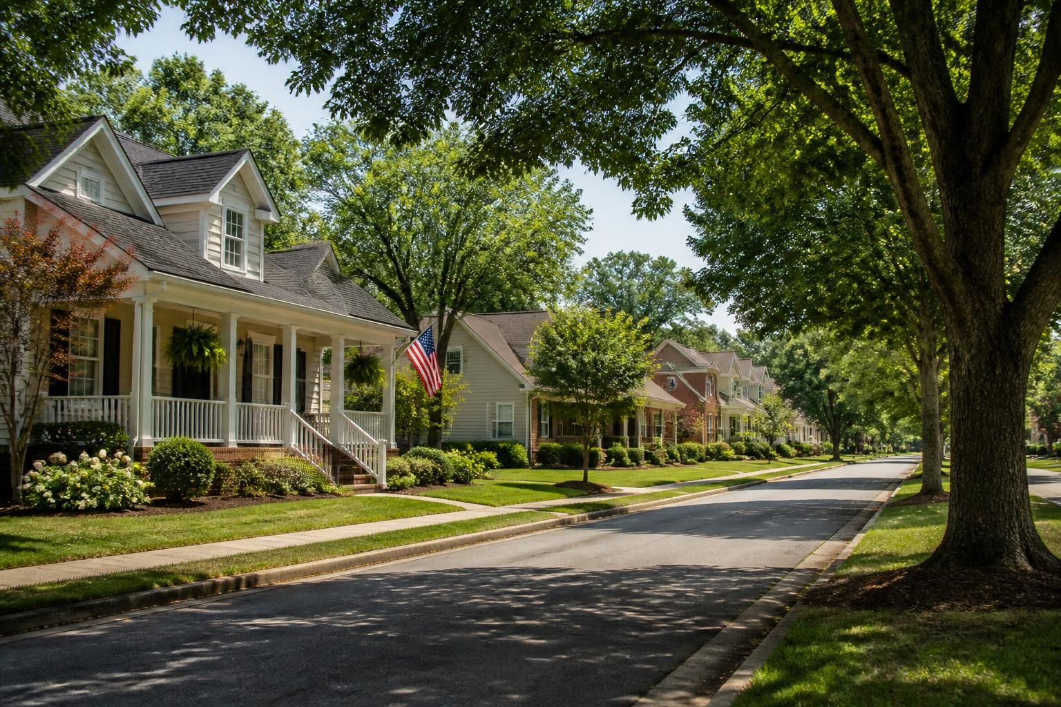 Tidy suburban street with mature trees and well-kept lawns in Commerce.