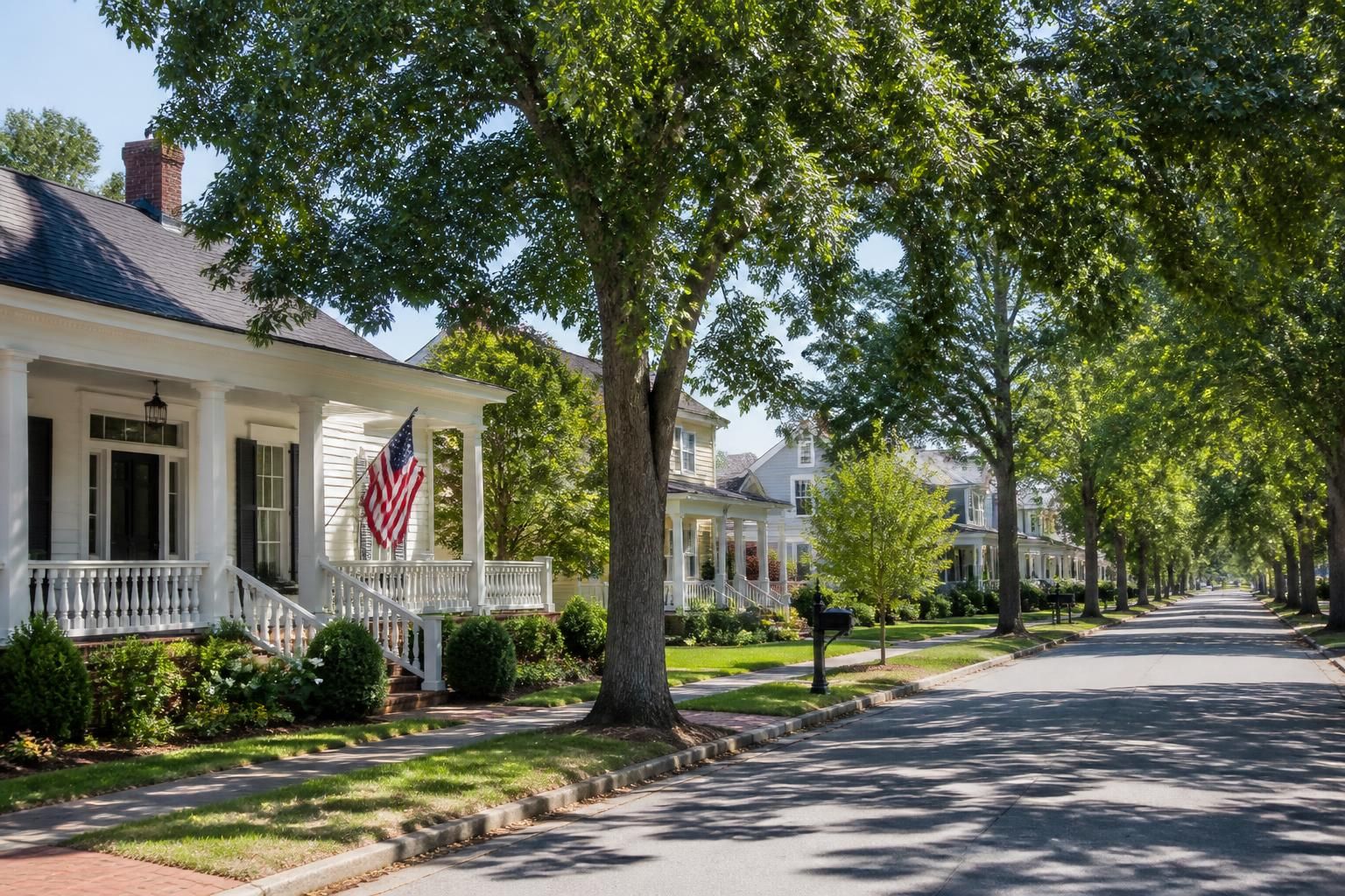Small-town street with tidy homes and mature trees in Jefferson.